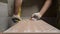 Close up on construction worker craftsman using tool for cutting ceramic tiles for laying installation to the bathroom