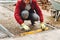 Close up of construction worker installing and laying pavement stones on terrace, road or sidewalk. Worker using pavement slabs an