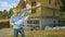 CLOSE UP: Contractor looks at floor plans in front of a house under construction