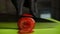 Close up of a cook in black gloves slices a fresh tomato