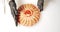 Close-up of cook`s hands in gloves serving a dish of daikon salad and slices of salmon with greens and red caviar