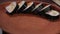 Close-up cook serving mouth-watering sushi rolls on wooden plate