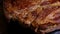 Close up of cooked beef steak with details of surface texture. Grilled meat background