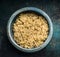 Close up of cooked quinoa seeds in rustic bowl, top view. Superfood, healthy eating