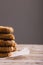 Close-up of cookies stacked on parchment paper against gray background, copy space