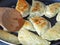 Close-up of cooking fried gyoza with vegetables in a frying pan.