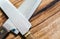 Close up of cooks knifes and wooden chopping board, top view wi