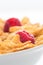 Close up of cornflakes and raspberry.