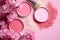 Close-up of cosmetic items on pink background