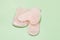 Close Up Cosmetic Massage Pink Jade Gua Sha Scrapers for Facial and Body Skin Care Spa and Beauty Concept Green Background