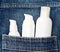 Close-up of cosmetic products containers in jeans pocket