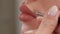 Close-up of a cosmetologist painting lips with a pencil before permanent makeup.