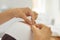 Close-up of cosmetologists hands making lifting massage movements on womans face and eyebrows