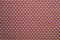 Close-up cotton lightweight fabric with a fine brown print. Background for the texture of outerwear and fashion
