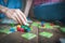 Close up of a couple in love sitting on the floor next to a table, playing ludo board game