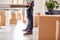 Close Up Of Couple In New Home On Moving Day Carrying Table Together