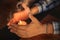 Close up of couple`s hands cupped around a burning candle. Hands of young man and woman that protect the flame of a candle. Love