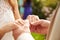 Close Up Of Couple At Wedding Holding Hands