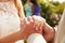 Close Up Of Couple At Wedding Holding Hands