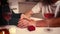 Close-up of couples hands giving support and love. Senior couple having romantic dinner at home in kitchen with wine and