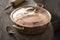 Close Up of Covered Copper Pot on Wooden Counter