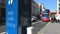 A close up of a COVID sign asking people to social distance and hand sanitise next to a road in London, as a Red London Double