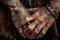 close-up of cowboy& x27;s tattooed hand, with leather and metal accessories visible