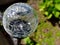 Close up of crackle glass solar led spotlight in the garden. Ene