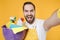 Close up of crazy man househusband in apron hold basin with detergent bottles washing cleansers doing housework isolated