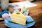 Close-up Cream cheese chiffon cake in a tiled plate decorated with rosemary leaves,