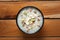 Close-up of Creamy Sabudana Kheer Garnished with dry fruits. Indian delicious dessert. Served in -black ceramic bowl. Top View