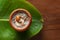 Close-up of Creamy Sabudana Kheer Garnished with dry fruits. Indian delicious dessert. Served in an earthen pot and banana leaf