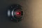 Close up of creative round black cctv camera on concrete wall background. Safety system and security concept.