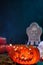 Close up of creepy orange pumpking on a wooden table for halloween party