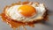 Close-up of a crispy fried egg with a runny yolk on a white surface