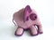 Close up of crochet animal. Lovely pink and purple elephant crochet knitted side view on white background