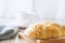 Close up of croissant with cup of coffee on wooden table with vi