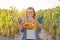 Close-up crop of ripe farm organic red tomatoes in basket in hands of woman