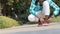 Close up Cropped image of young man in casual clothing sitting on the footpath in public park and tie shoe lace while jogging and