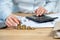 Close up cropped investor or sale manager lady in her formal wear shirt she put money in pile sit behind table in bright loft int