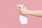 Close up cropped photo of female housewife hold in hands atomizer spray with washing cleanser isolated on pastel pink