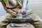 Close up cropped photo of lady in her workwear she sit inside workspace production ceramics clay product by hands enjoy process