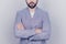 Close up cropped portrait of young handsome brunet bearded businessman lawyer in grey jacket. He stands on pure light background.