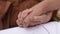 Close-up cropped shot of unrecognizable happy young couple holding hands. Close up of hands of lovely loving man and
