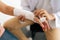 Close-up cropped shot of unrecognizable male doctor examination injured female patient with broken hand wrapped in