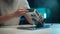 Close-up cropped shot of unrecognizable man cleaning case of modern desktop video game card using wet wipes, during