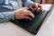 Close-up cropped shot of unrecognizable senior older businessman typing on laptop keyboard. Closeup wrinkly hands of