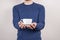 Close-up cropped view photo picture of confident nice positive guy holding cup of tasty delicious tea in hands isolated grey