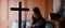 Close up cross is blur background. Asian Christian woman and man holding hands in praying for Jesus` blessings to show love and