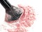 Close up of crushed blush on white background and cosmetic brush.
